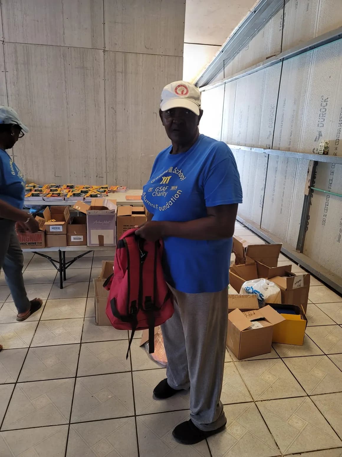 Volunteer holding a backpack ready for distribution