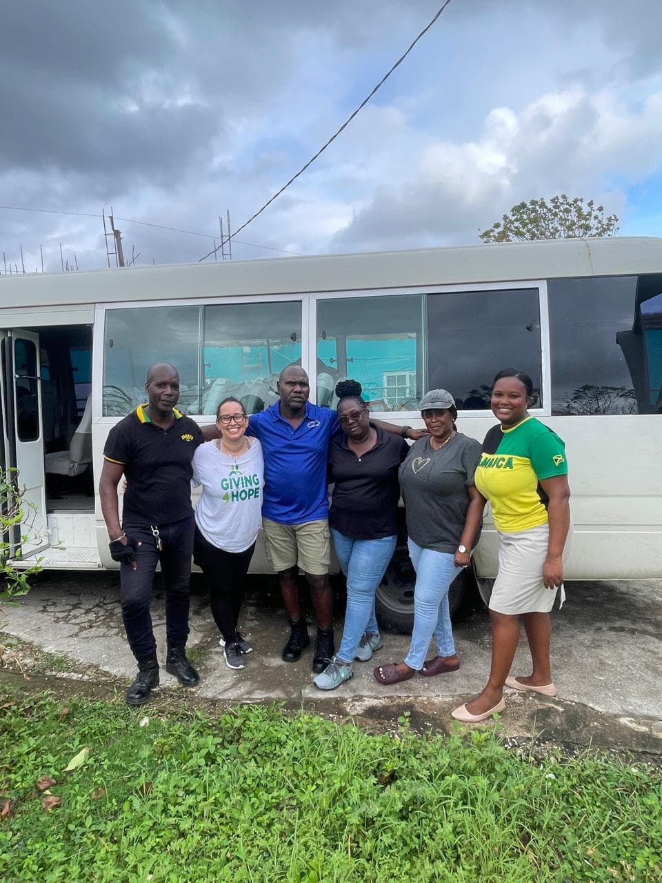 Volunteer handing relief supplies to a young child in the community