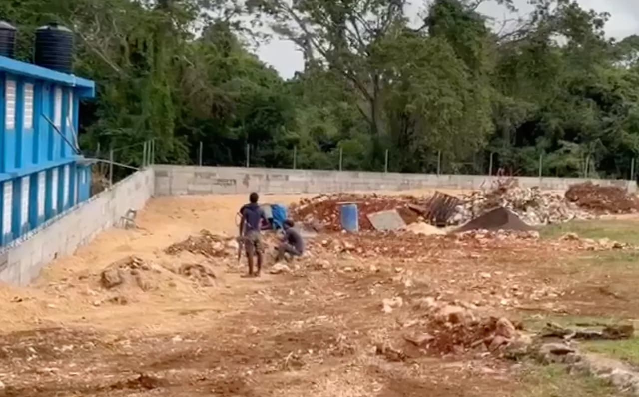Workers continuing construction on the playing field