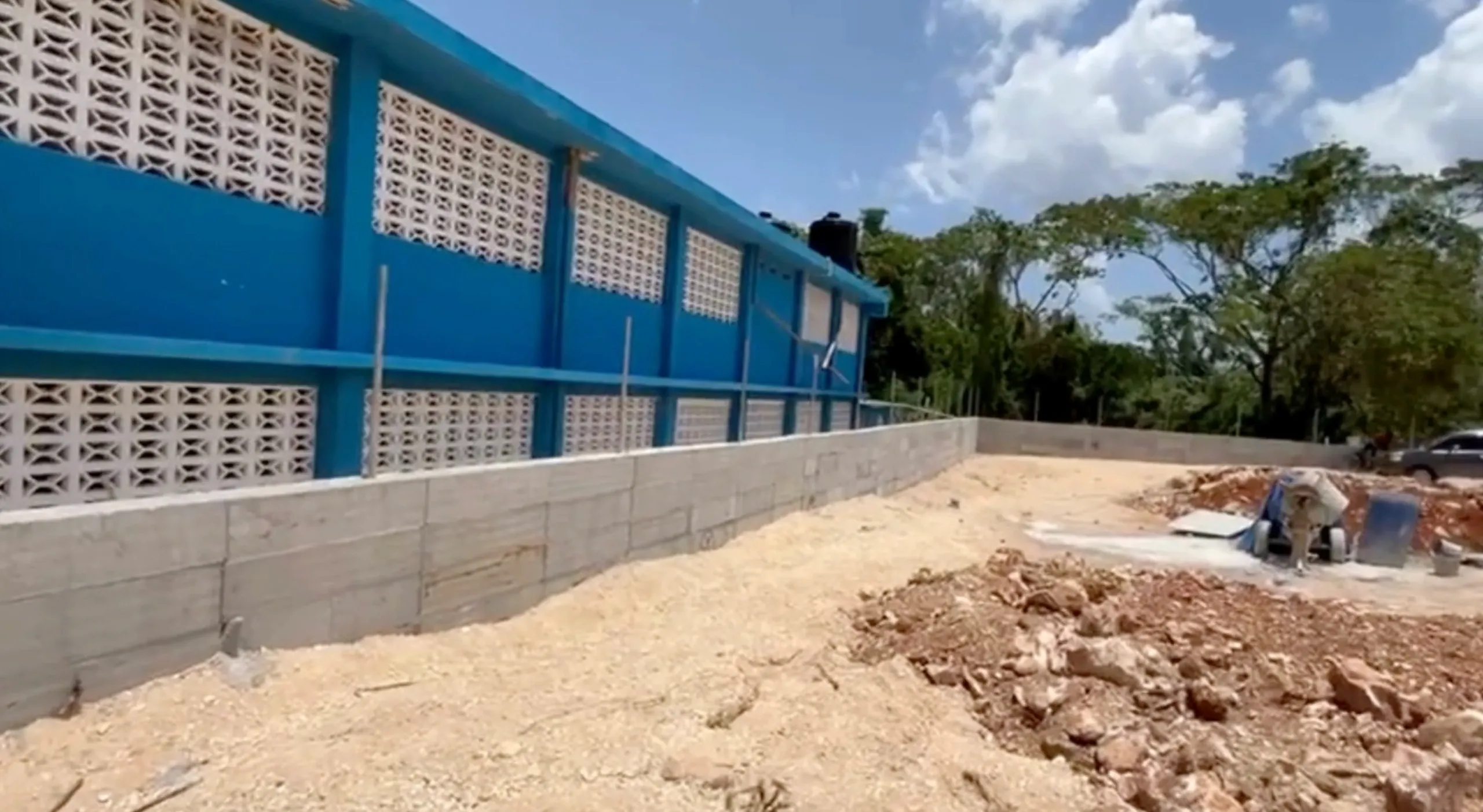 Block wall construction progress along the school