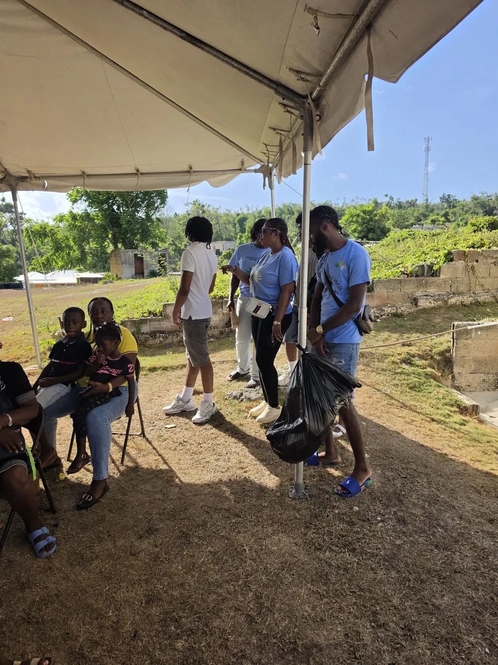 Foundation representatives and attendees talking beneath the event tent